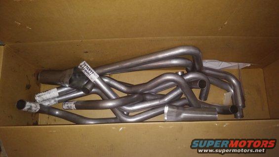 Exhaust headers in a cardboard box with a label reading 2175937