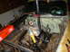 1953 Plymouth Belvedere - The engine is being removed from a 1953 Plymouth Belvedere using an engine hoist and a work light.