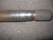 1988 Ford Bronco - Close-up of a rusted metal shaft with splined end, likely a vehicle component.