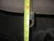 1988 Ford Bronco - A tape measure is used to measure a metal bracket, likely a vehicle part.