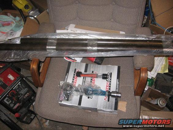 MasterPro tie rod ends and drag link assembly in boxes on a chair, with a long metal shaft wrapped in plastic above