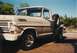 1968 Ford F-100 - A tan 1967 Ford F-100 pickup truck is parked outdoors under a clear blue sky.