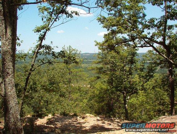 Wooded landscape with distant view and Supermotors.net watermark