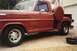 1967 Ford F-100 - A red 1967 Ford F-100 pickup truck is parked outside a garage on a cold day, with icicles hanging from the wheel wells.