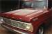 1967 Ford F-100 - A red 1967 Ford F-100 pickup truck is covered in a light dusting of snow.