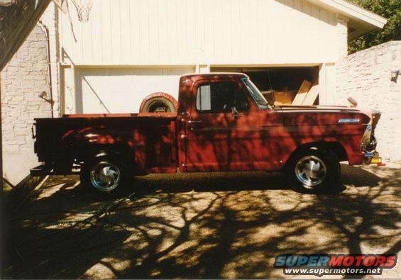 Red 1967 Ford F-100 pickup truck, side view