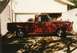 1967 Ford F-100 - This red 1967 Ford F-100 pickup truck is parked in front of a garage.