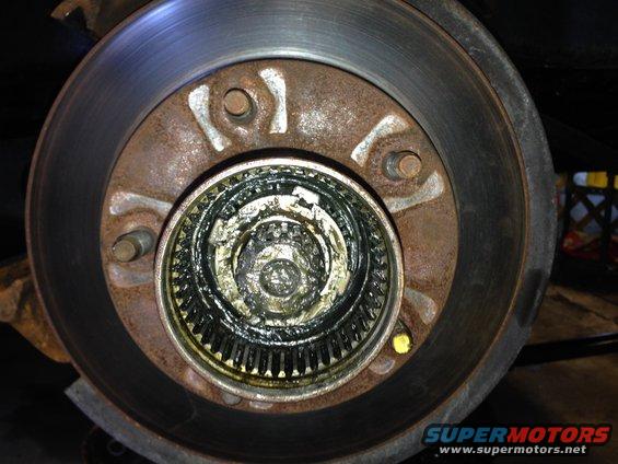 Lock washer.  You'll need a special 4-prong socket to unlock.  You can get them at any auto parts store.  Or ask around.  Someone is bound to have one.