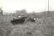1967 Ford F-100 - A 1967 Ford F-100 pickup truck lies on its side in a field after an apparent accident.