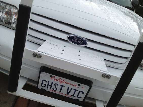 White Ford Crown Victoria grille with California GHST VIC license plate