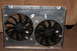 1995 Ford Bronco - A pair of electric cooling fans are mounted in a metal shroud, likely for an automotive application.