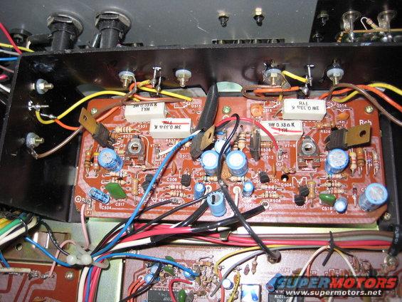 Close-up of an electronic circuit board with resistors, capacitors, and wires