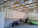 1995 Mercury Grand Marquis - A green 1970s muscle car is parked inside a garage that is being insulated.