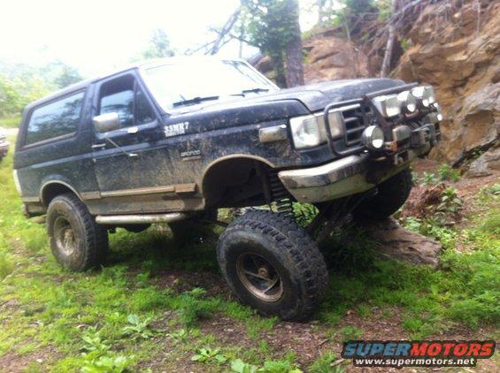 1988 Ford Bronco with off-road modifications on a rocky trail