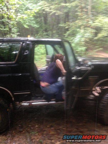 1988 Ford Bronco with driver's door open, person climbing in
