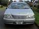 1999 Ford Fairlane - Silver sedan with license plate LG52 XVL parked on a residential street.