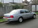 1999 Ford Fairlane - A silver sedan is parked on the side of a residential street, viewed from the rear quarter.