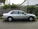 1999 Ford Fairlane - This silver sedan, identified by a 'Fairlane' badge on the fender, is seen from the side.