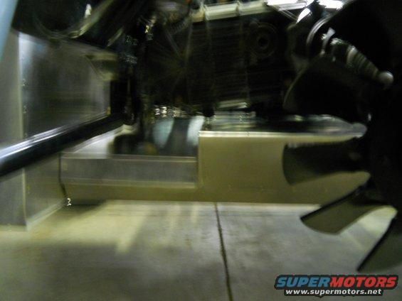 Close-up of a fan blade and metal housing in an engine bay