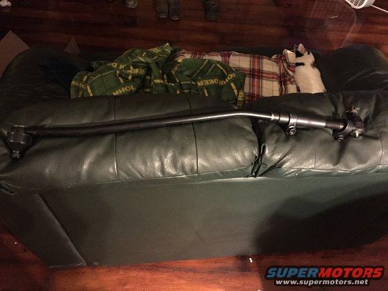 Tie rod assembly on a dark green leather couch