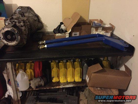 Transmission and blue control arms on a shelf