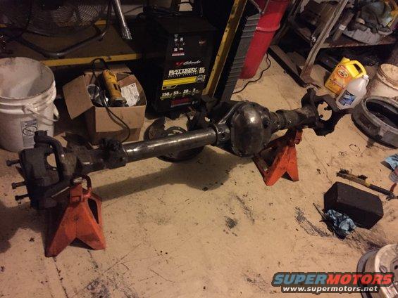 Ford Bronco rear axle assembly on orange jack stands in a garage