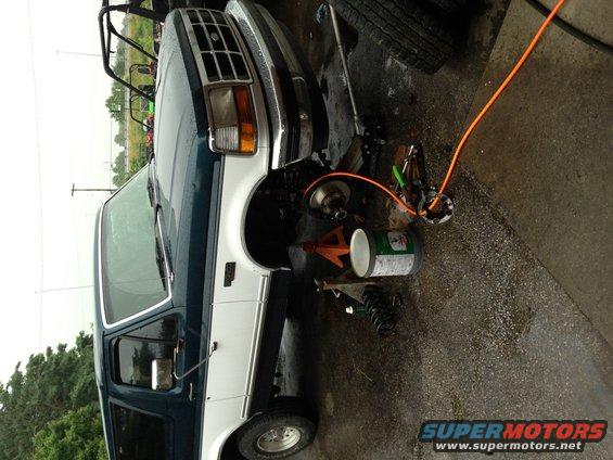 1994 Ford Bronco front suspension work with jack stands and tools