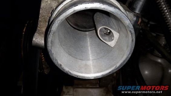 Close-up of a throttle body opening with a sensor inside