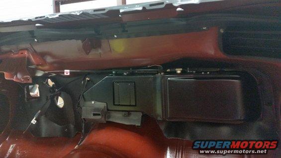 car dashboard with heater box and ducting visible