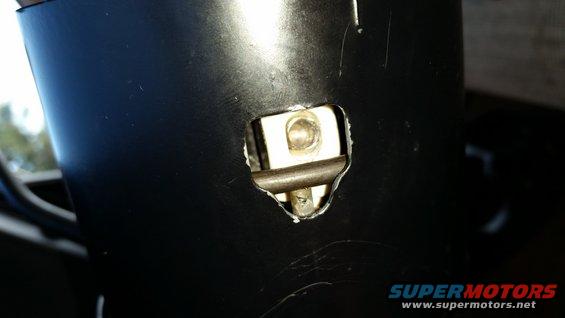 Close-up of a metal mechanism inside a black steering column