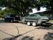 1968 Mercury Cougar - A green 1968 Mercury Cougar is loaded onto a trailer, ready for transport by a black pickup truck.