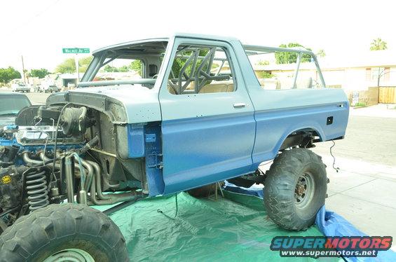 Ford Bronco body with roll cage, unfinished, two-tone blue and gray paint, large off-road tires