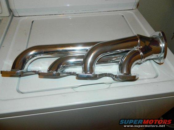 Chrome exhaust headers on a white surface