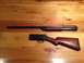 1996 Ford Bronco - Disassembled shotgun barrel and wooden stock laid out on a wood grain surface.