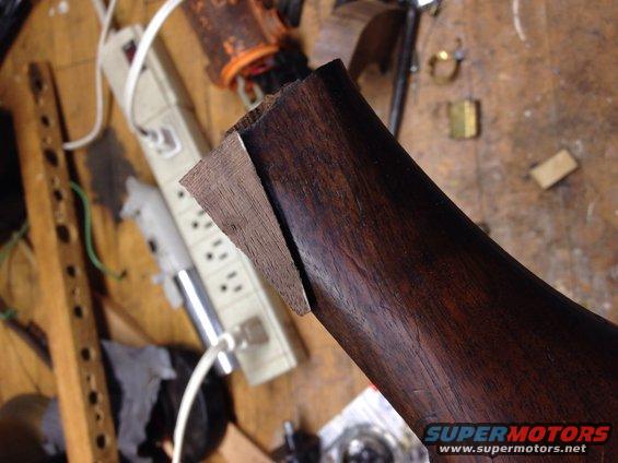 Wood part with lighter wood inlay and visible grain