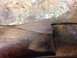 1996 Ford Bronco - Detail of wood trim on a surface, showing grain and wear.