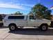 1977 Ford F-350 - This 1977 Ford F-350 pickup is equipped with a white camper shell and aftermarket wheels.