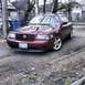 2004 Mercury Marauder - This maroon 2004 Mercury Marauder sedan is viewed from the front three-quarter angle, showing its distinctive grille and alloy wheels.