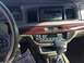 1995 Mercury Grand Marquis - The dashboard of a car features wood grain trim, a digital clock, and an audio system display.