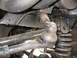 1988 Ford Bronco - Undercarriage view of suspension components, including a ball joint and coil spring.