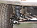 1988 Ford Bronco - Close-up of the front suspension and tire assembly on a 1988 Ford Bronco.
