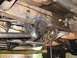 1988 Ford Bronco - A close-up view of the undercarriage reveals various mechanical components and suspension parts.