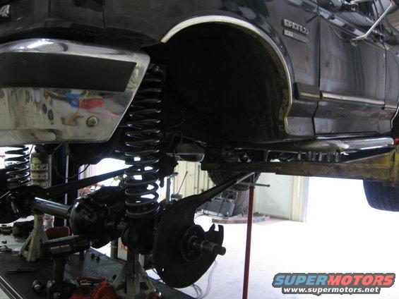 Side view of a lifted 1988 Ford Bronco's suspension with heavy-duty springs and shocks