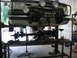 1988 Ford Bronco - 1988 Ford Bronco front end undergoing maintenance on a vehicle lift in a garage.