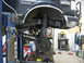 1988 Ford Bronco - The front suspension of a 1988 Ford Bronco is visible as it's lifted for service in a garage setting.