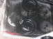 1988 Ford Bronco - Close-up view of a black painted metal component several circular indentations.