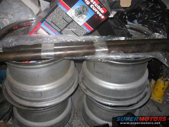 Stack of aluminum wheels with a metal bar on top, and a box labeled 'Adjustable Curves'