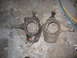 1988 Ford Bronco - Two vehicle steering knuckles are shown side-by-side on a workshop floor, with visible part numbers.
