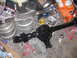 1988 Ford Bronco - A freshly painted rear axle assembly sits on jack stands, surrounded by parts and tools, suggesting a vehicle repair or upgrade project.