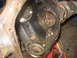 1988 Ford Bronco - Close-up view of a dirty and rusty differential housing, showing internal components.
